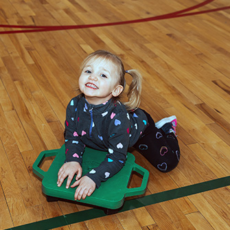 preschool student smiling for the camera from the gym