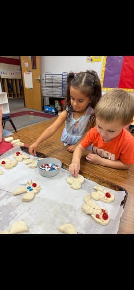 Preschoolers shaping dough together
